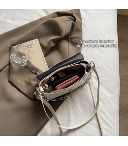 Detailed view of cream baguette bag interior showing large capacity for essentials