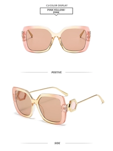Detail view of pink yellow gradient square sunglasses with gold metal temples and hinges