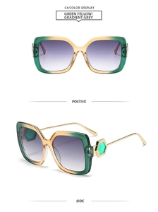 Detail view of square green-yellow sunglasses with golden metal temples and side hexagon motif