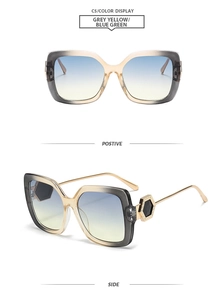 Detail view of square frame sunglasses with blue-green gradient lenses and gold temple decor