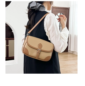 Detailed view of vintage lychee texture leather shoulder bag with dark brown corner accents