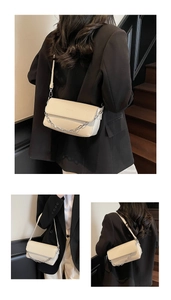 Detail of cream flap bag with silver chain strap and shiny leather finish in lifestyle view