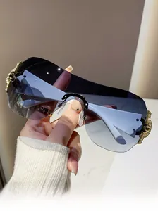 Detail of rimless Y2K sunglasses with crystal-set golden metal hinge and gradient lenses