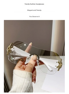 Detail of white wide temples with gold openwork and rhinestones on Y2K sunglasses