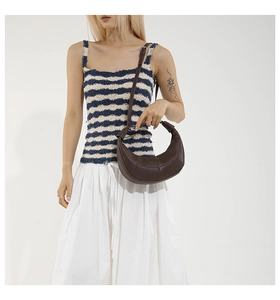 Detailed view of dark brown crescent hobo bag with litchi texture and adjustable strap