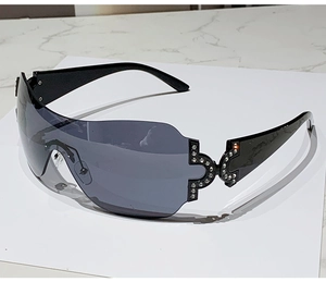 Detailed view of luxury Y2K rimless sunglasses with rhinestone accents on the temples