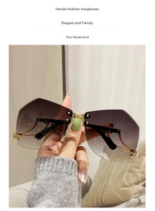 Detail of rimless polygon sunglasses with purple gradient lenses and gold metal accents