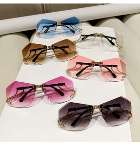 Detail view of multi-colored rimless geometric sunglasses with gold metal temples