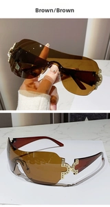 Detail of Y2K rimless sunglasses featuring a crystal-encrusted C-shape metal hinge design