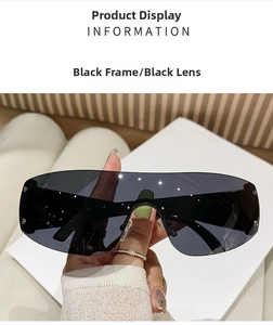 Detail of black rimless Y2K sunglasses with silver stud accents on the lenses