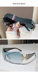 Detail of grey-green rimless sunglasses with gold diamond-encrusted temple accents