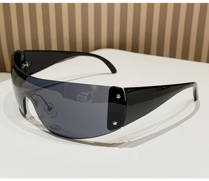 Detail of Y2K rimless sunglasses featuring silver star rivets and dark grey lens