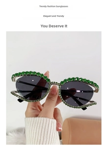 Détail de lunettes œil-de-chat ornées de strass verts et verres noirs teintés