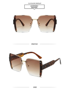 Close-up of square rimless sunglasses with leopard print temples and brown gradient lenses