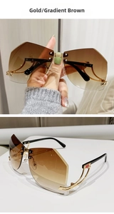 Close-up of gold rimless Y2K sunglasses with gradient brown lenses and metal frame