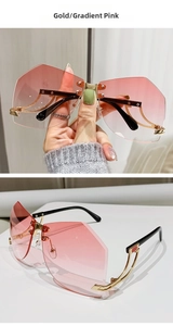 Detail of rimless geometric sunglasses with gold metal frame and gradient pink lenses