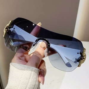 Frameless oversized Y2K sunglasses with gradient blue lenses and gold rhinestone accents