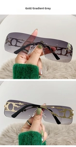 Detail of Y2K rimless sunglasses with gold flame metal temples and gradient grey lenses