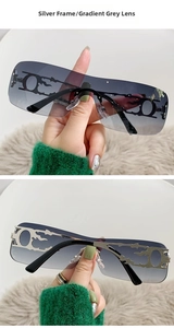 Detail of silver frameless Y2K sunglasses with hollow flame metal temples and gray lenses