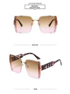 Detail of square rimless sunglasses with brown pink gradient lenses and floral temples