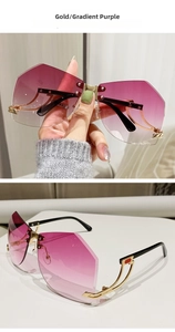 Detail of gold rimless sunglasses with purple gradient lenses and geometric hollow temples