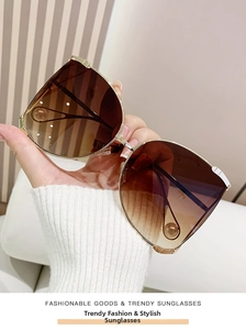 Detail of Y2K D-frame sunglasses with golden metal temples and teardrop ball accents