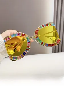 Macro shot of D-shaped gold metal frame with rainbow gradient crystals and yellow lens