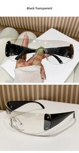 Detail of rimless shield sunglasses with black temples, transparent lenses and star rivets