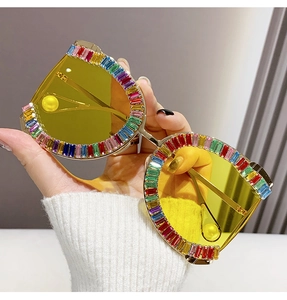 Detail of D-frame sunglasses featuring colorful rhinestones and gold metal temples