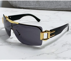 Détail de lunettes de soleil carrées Y2K avec charnières en métal doré et branches noires
