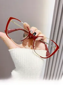 Detailed view of red and gold cat-eye metal glasses frame with modern stylish design