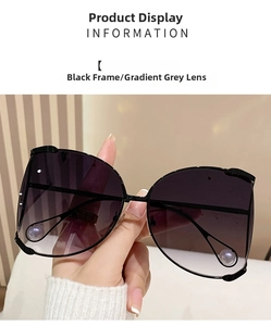Detail of oversized D-frame sunglasses with gradient grey lenses and white pearl accents