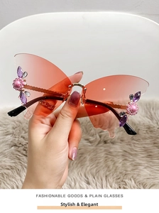 Detail of butterfly rimless sunglasses with gradient lenses and rhinestone flower accents