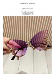 Close-up of frameless butterfly sunglasses with purple gradient lenses and rhinestones