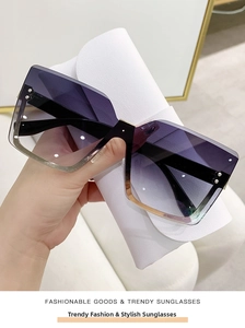Detail view of square rimless sunglasses with purple gradient lenses and gold trim