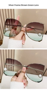 Close-up of silver metal D-frame sunglasses with brown green gradient lenses and pearls