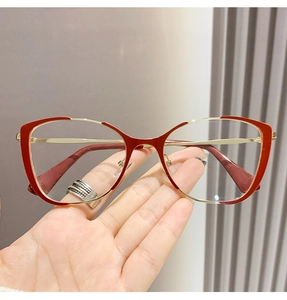 Detail of red and gold metal cat-eye eyeglass frame with stylish anti-slip temple tips