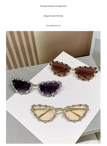 Detailed view of luxury cat-eye sunglasses featuring dense rhinestone-encrusted metal frames