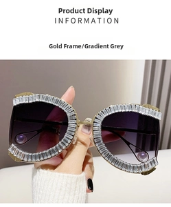 Close-up of gold metal frame sunglasses with crystal rhinestones and gradient grey lenses
