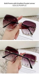 Detail of butterfly rimless sunglasses with gradient purple lenses and gold chain temples