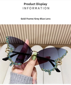 Close-up of golden butterfly wing sunglasses with colorful rhinestones and blue gradient lens