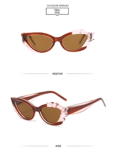 Detailsicht der teefarbenen Cat-Eye-Sonnenbrille mit rosa Kristall-Blumenverzierung