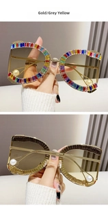 Detail of gold metal frame sunglasses with rainbow rhinestones and pearl tips