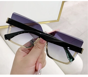 Detailed close-up of rimless gradient purple lenses with luxury gold metal edge trim
