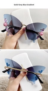 Detail of rimless butterfly sunglasses with grey-blue gradient lenses and floral crystals