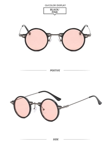 Detail of round retro sunglasses with black frames and pink lenses including side view