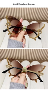 Close-up of butterfly wing sunglasses with gradient brown lenses and gold rhinestones