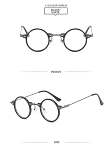 Detail of round retro glasses with black frame, metal bridge and silver rivets