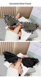 Detailed view of gunmetal cat-eye sunglasses featuring luxury rhinestone-encrusted frames