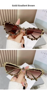 Detail of cat eye sunglasses with gold metal frame and amber crystal embellishments